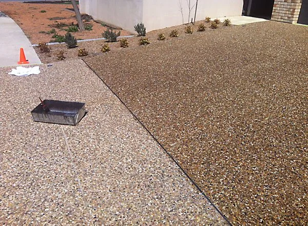 Fresh concrete driveway sealer being applied